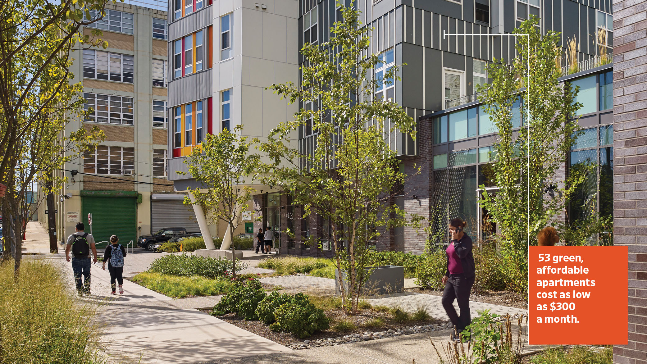Paseo Verde, an affordable, sustainable housing complex in North Philadelphia, features a green street in the foreground and a building with an interior courtyard.